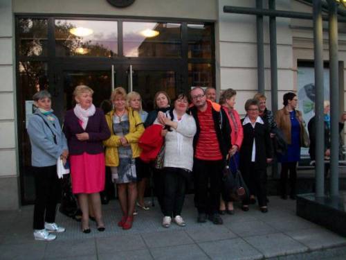 Grupa uczestników i uczestniczek wyjazdu stojąca przed wejściem do Teatru Zagłębia